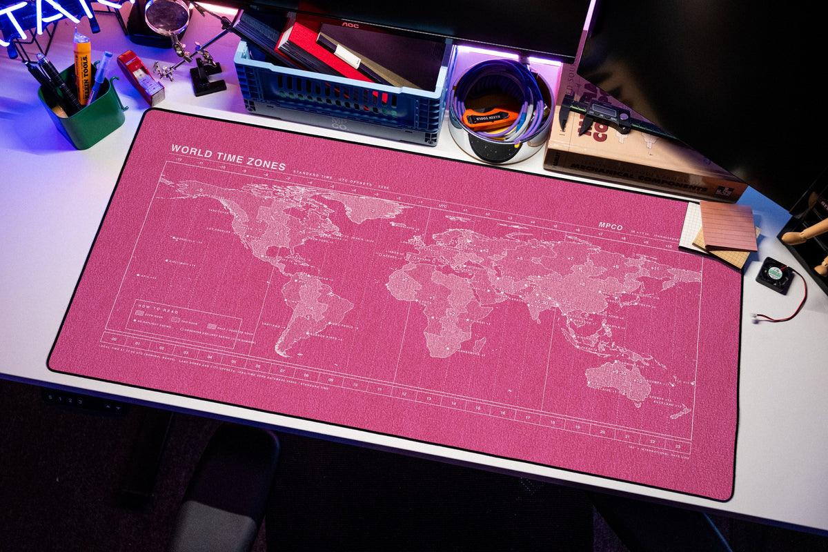 World Time Zones Map Pad desk mat in Pink / White, shown on a styled desk setup