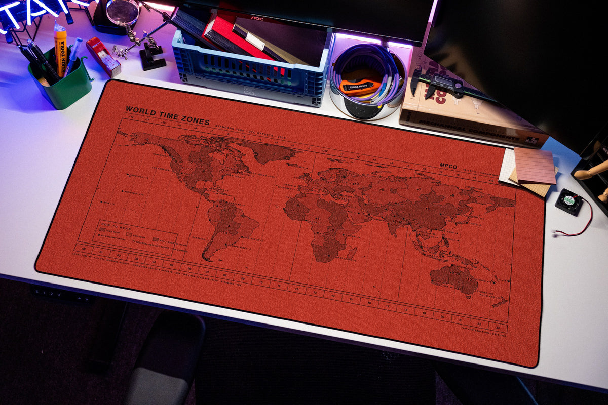 World Time Zones Map Pad desk mat in Red / Black, shown on a styled desk setup