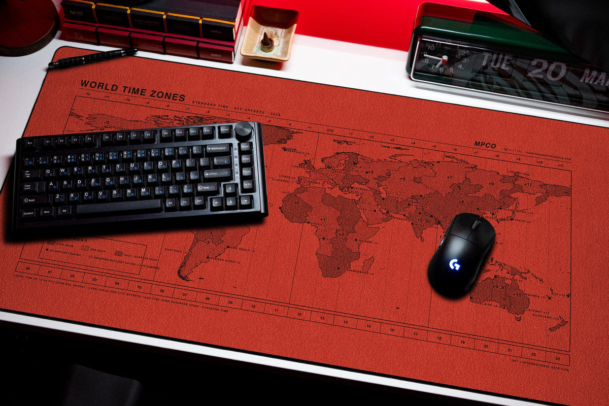 World Time Zones Map Pad desk mat in Red / Black, shown on a styled desk setup