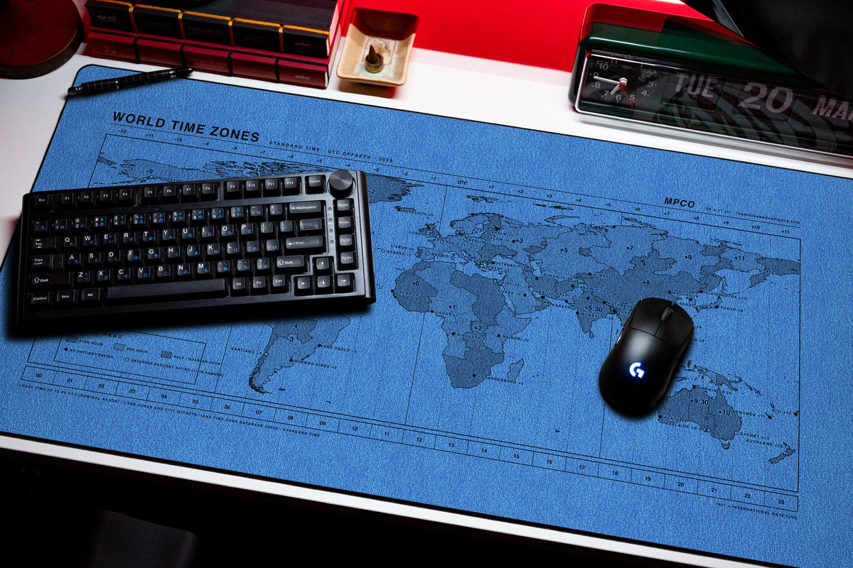 World Time Zones Map Pad desk mat in Swiss Blue, shown on a styled desk setup