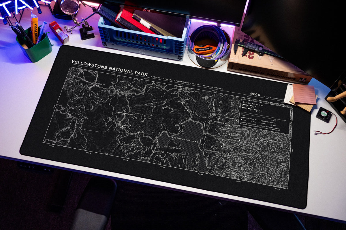 Yellowstone National Park Topo Pad desk mat in Black / White, shown on a styled desk setup