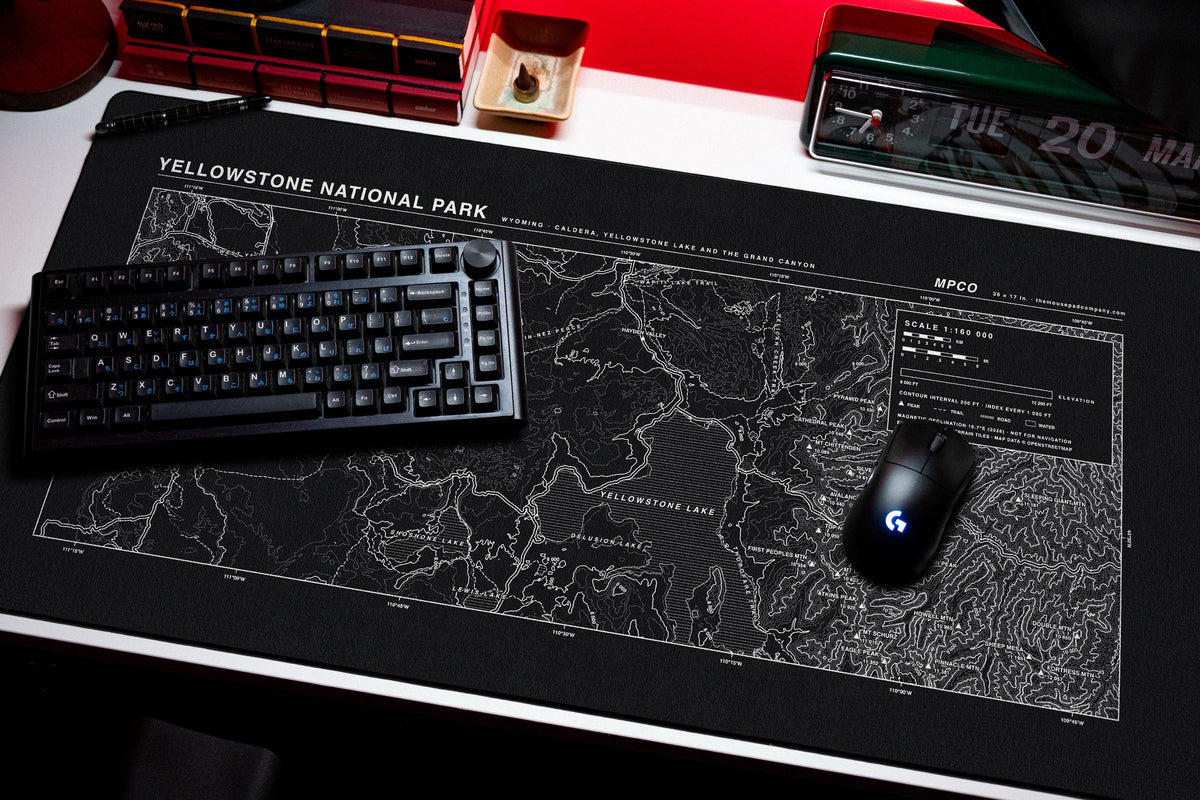 Yellowstone National Park Topo Pad desk mat in Black / White, shown on a styled desk setup