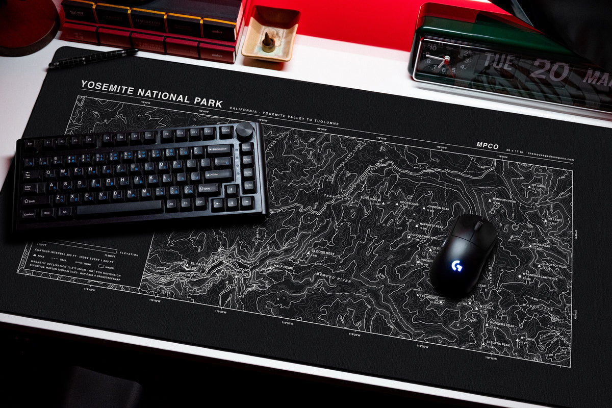 Yosemite National Park Topo Pad desk mat in Black / White, shown on a styled desk setup