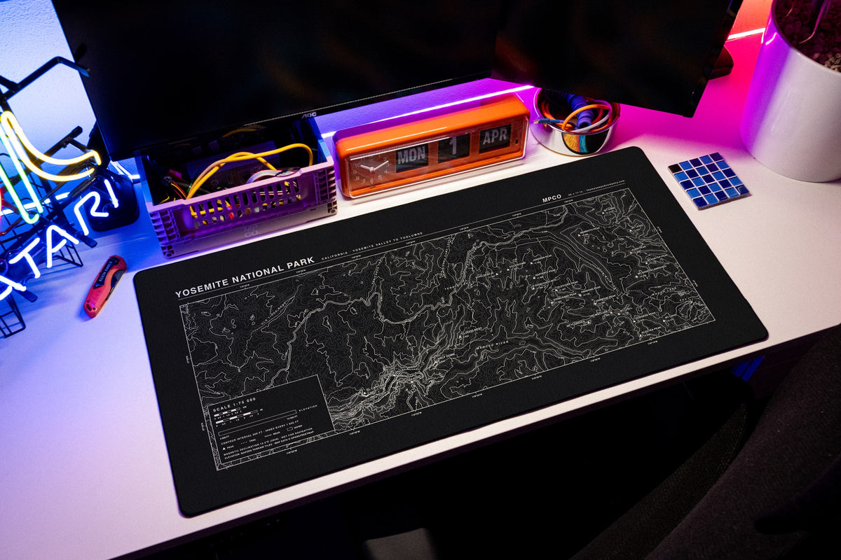 Yosemite National Park Topo Pad desk mat in Black / White, shown on a styled desk setup