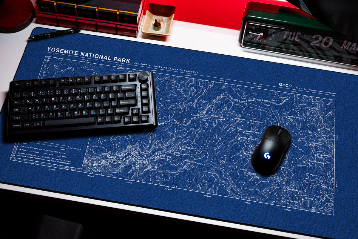 Yosemite National Park Topo Pad desk mat in Blue / White, shown on a styled desk setup