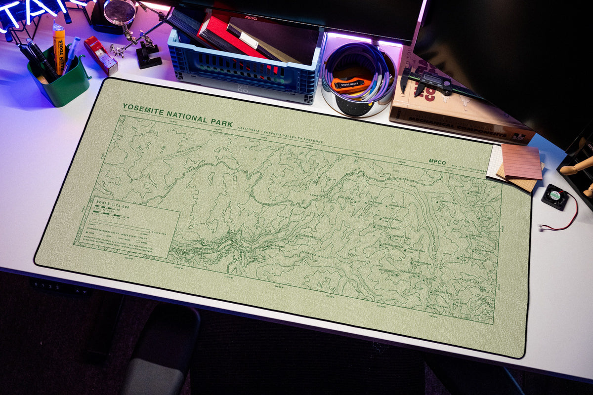 Yosemite National Park Topo Pad desk mat in Buff / Green, shown on a styled desk setup