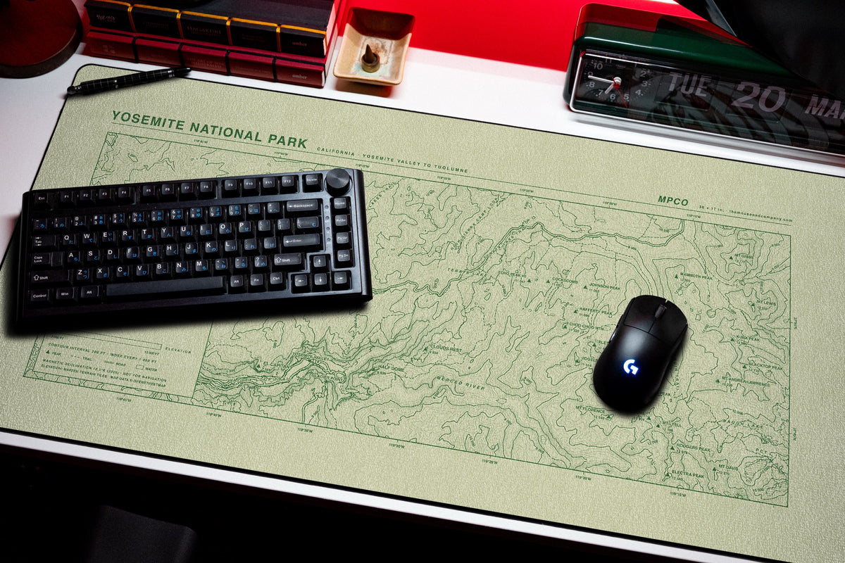 Yosemite National Park Topo Pad desk mat in Buff / Green, shown on a styled desk setup