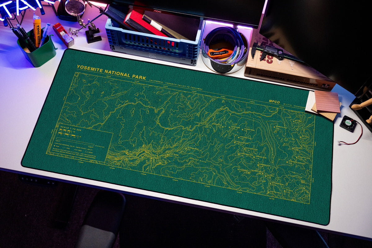 Yosemite National Park Topo Pad desk mat in Green / Yellow, shown on a styled desk setup