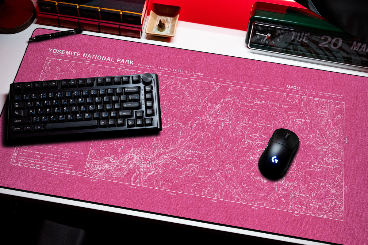 Yosemite National Park Topo Pad desk mat in Pink / White, shown on a styled desk setup