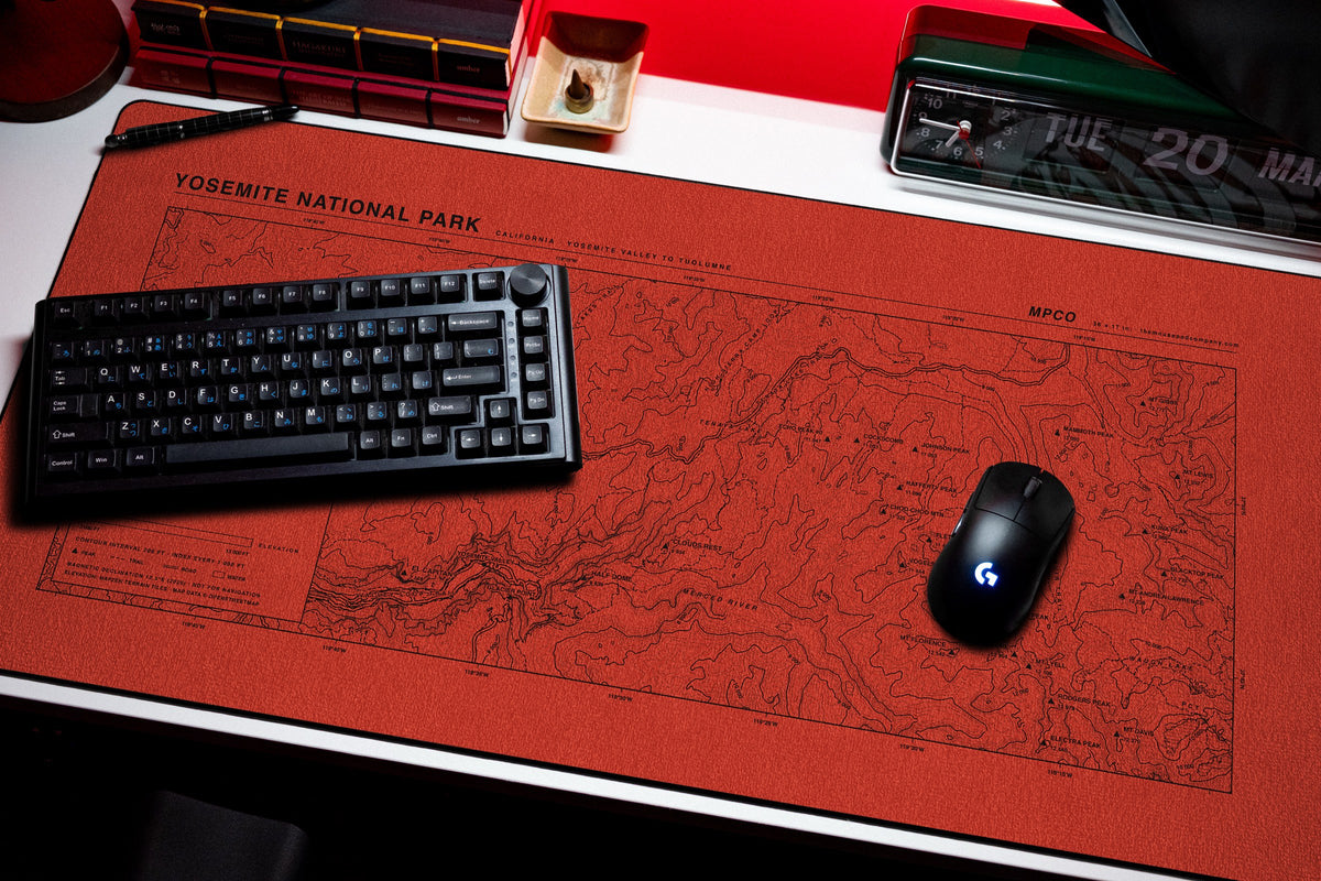 Yosemite National Park Topo Pad desk mat in Red / Black, shown on a styled desk setup
