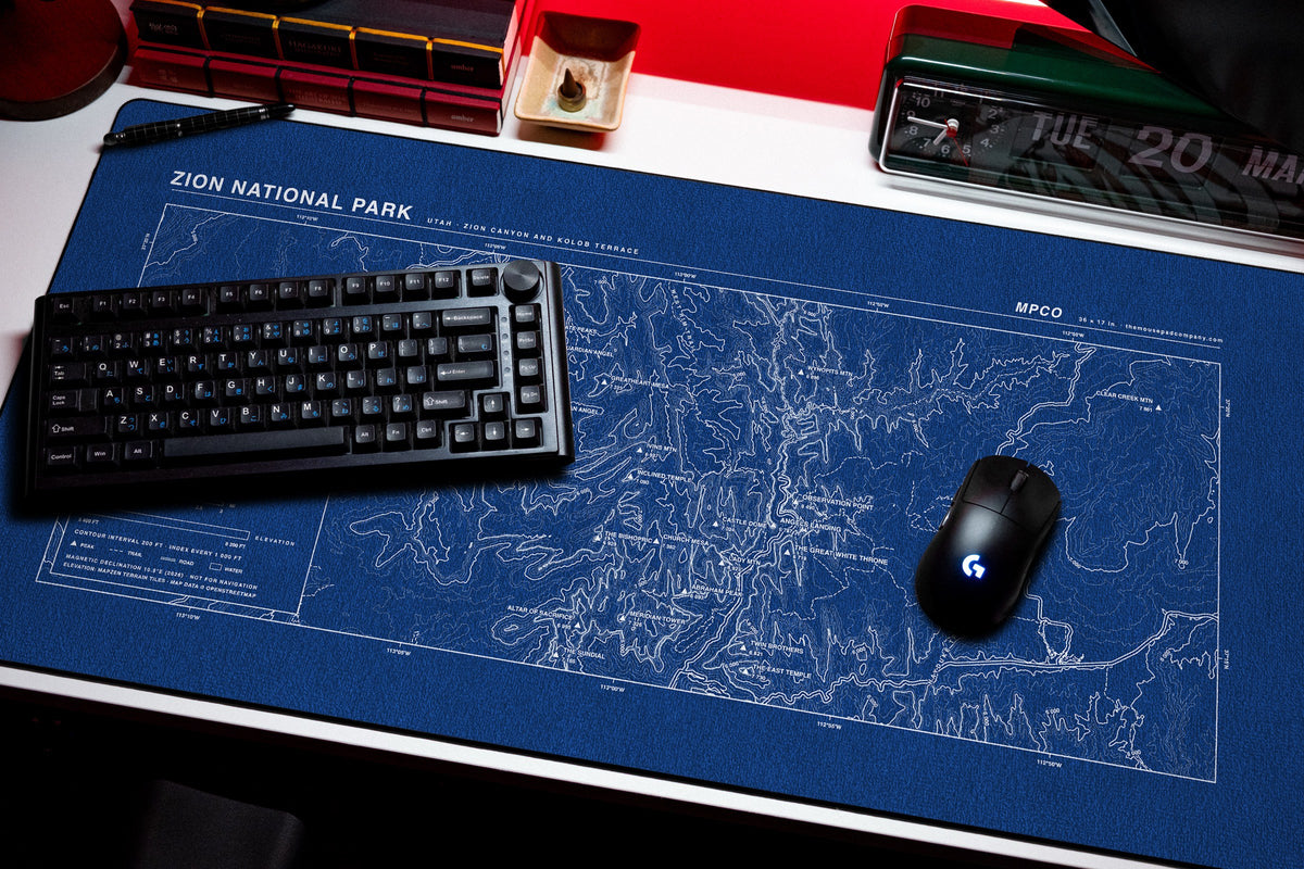 Zion National Park Topo Pad desk mat in Blue / White, shown on a styled desk setup