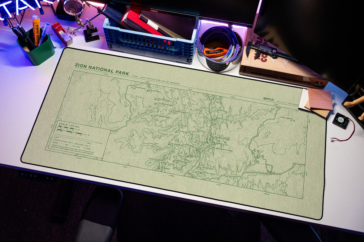 Zion National Park Topo Pad desk mat in Buff / Green, shown on a styled desk setup