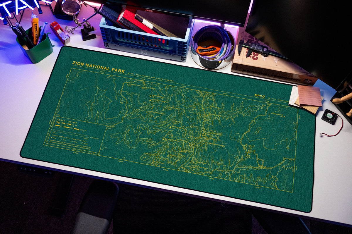 Zion National Park Topo Pad desk mat in Green / Yellow, shown on a styled desk setup