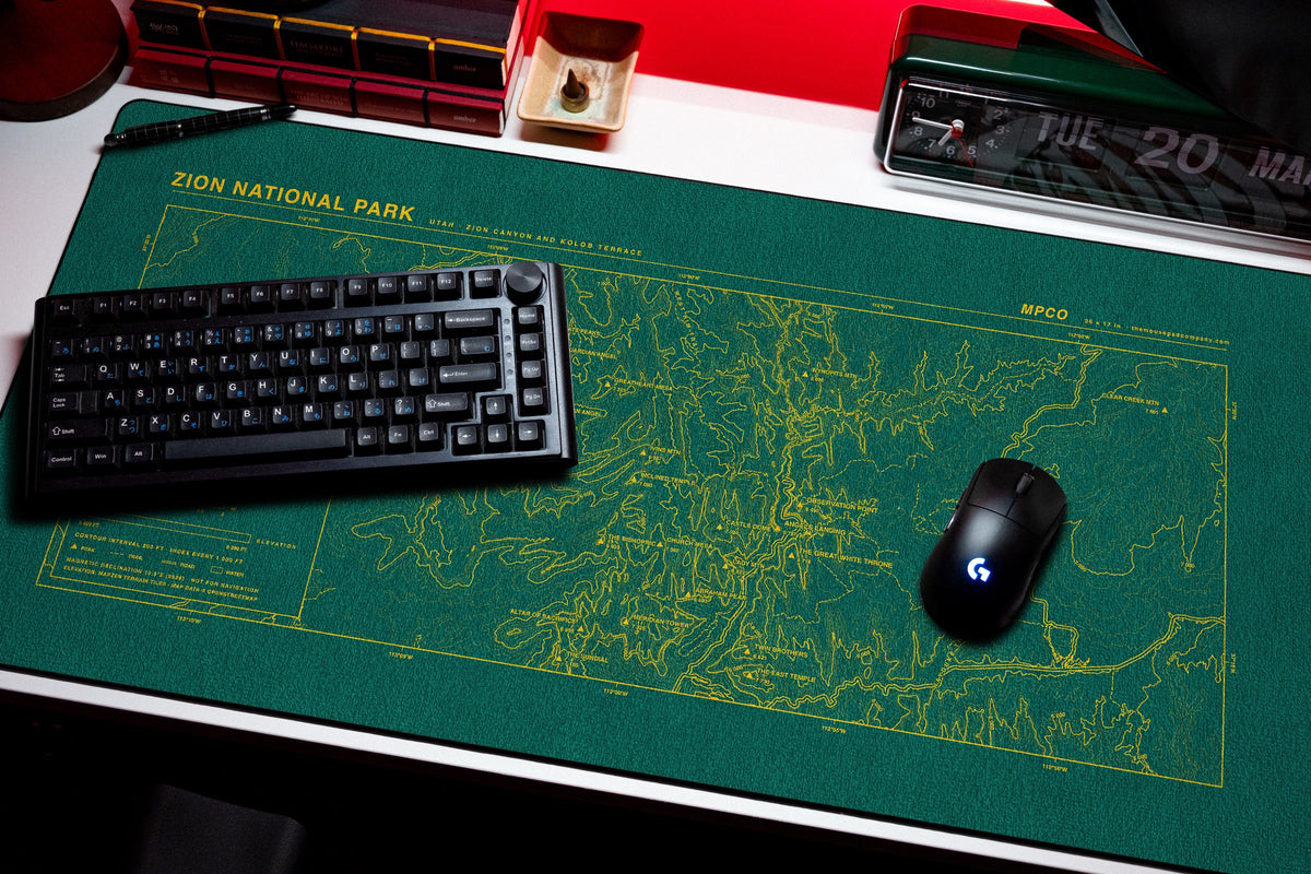 Zion National Park Topo Pad desk mat in Green / Yellow, shown on a styled desk setup