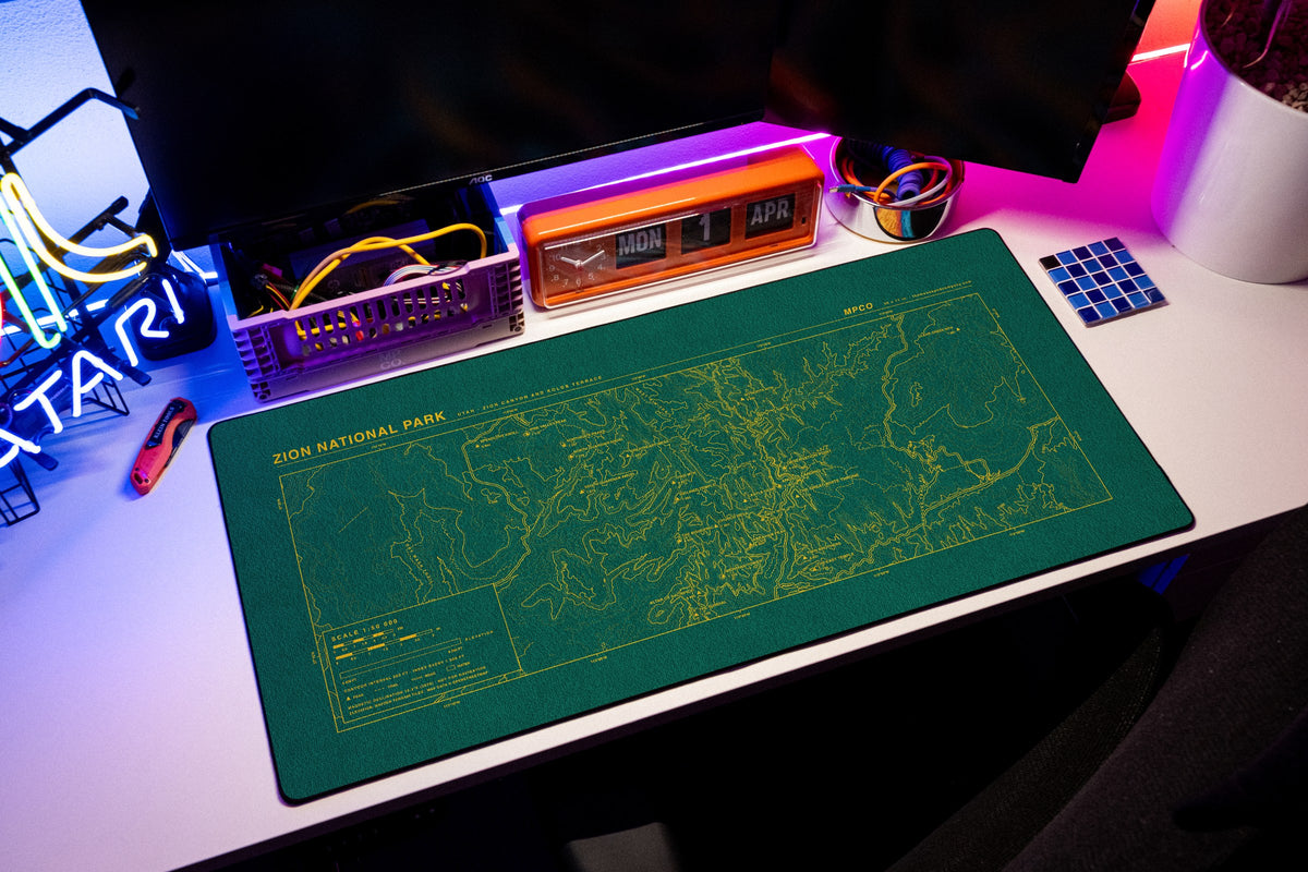 Zion National Park Topo Pad desk mat in Green / Yellow, shown on a styled desk setup