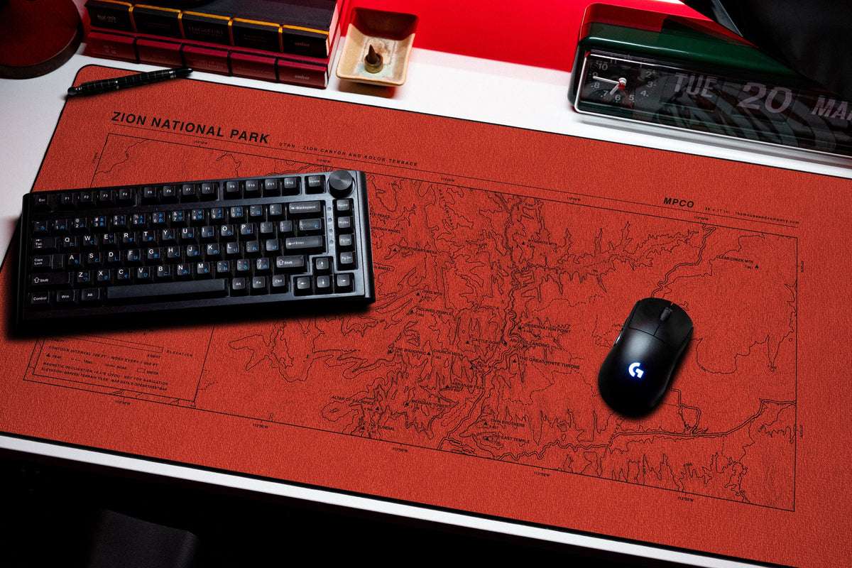 Zion National Park Topo Pad desk mat in Red / Black, shown on a styled desk setup